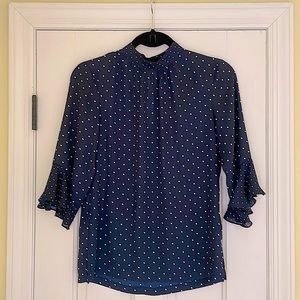 Navy polka dot mock neck bell sleeve blouse